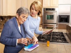 Nurse helping a senior in their home kitchen 